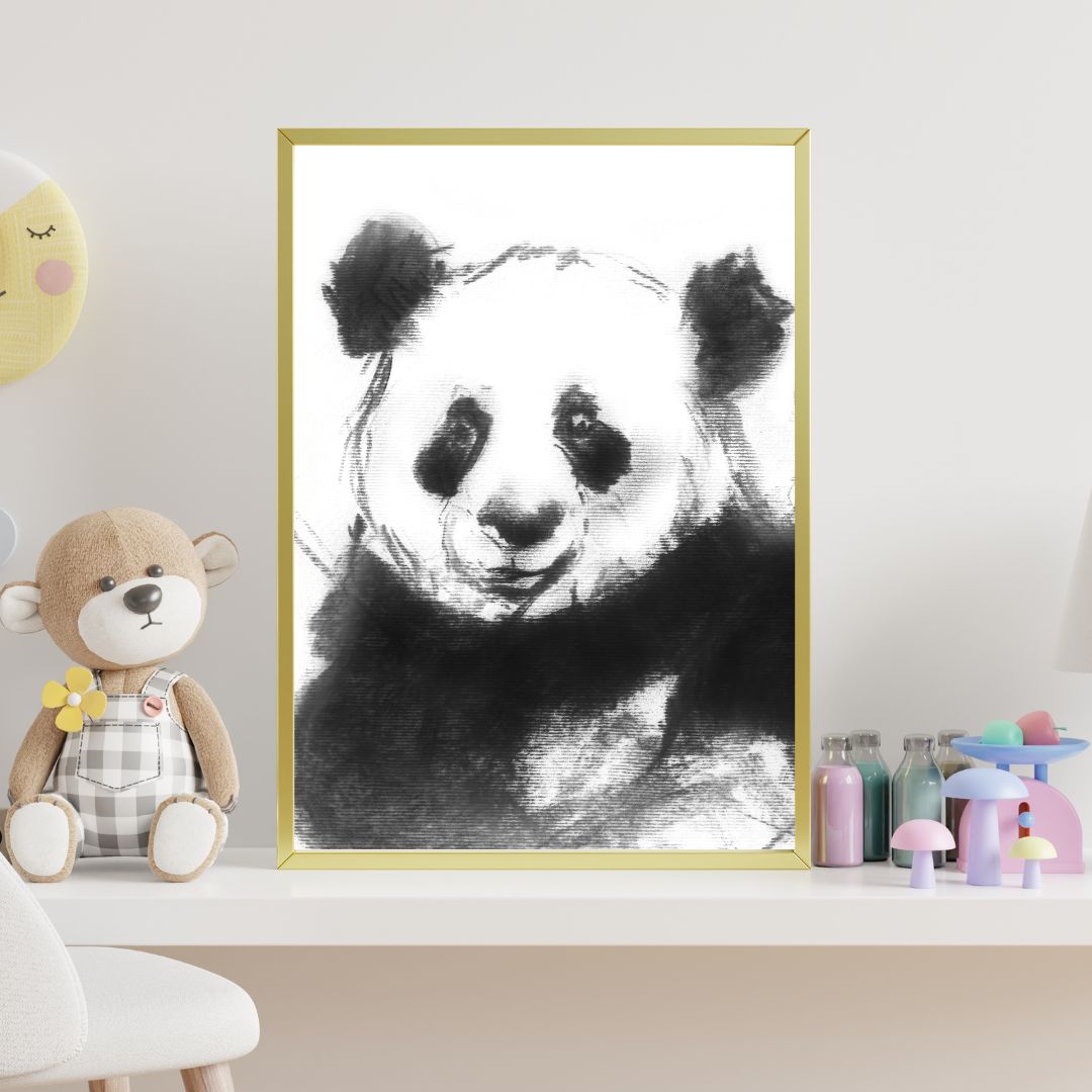 Framed panda nursery wall art featuring an ink and charcoal wildlife illustration, styled on a shelf in a softly decorated children’s room with neutral tones.